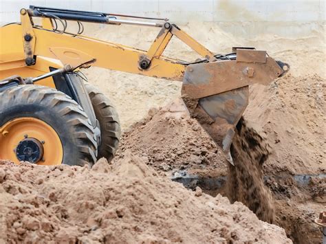 backfilling foundation with skid steer|backfilling a foundation trench.